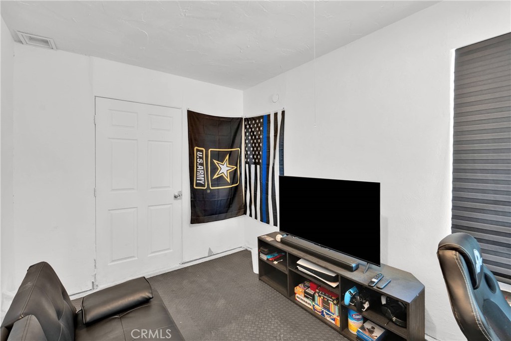 14769 Nanticoke Road Apple Valley, CA 92307 - Photo 25 of 30 a living room with furniture and a flat screen tv