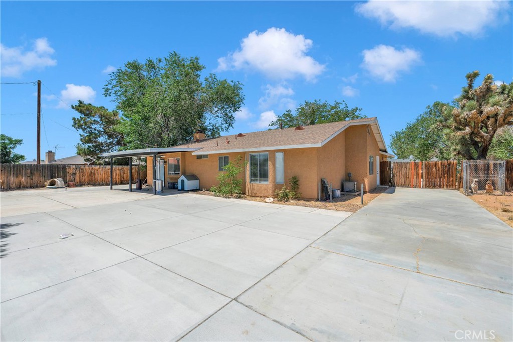 14769 Nanticoke Road Apple Valley, CA 92307 - Photo 29 of 30 a view of a house with backyard and trees