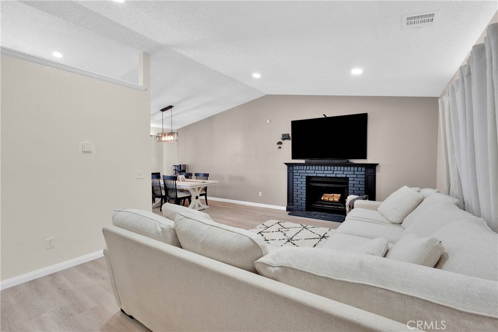 14769 Nanticoke Road Apple Valley, CA 92307 - Photo 3 of 30 a living room with fireplace furniture and a flat screen tv