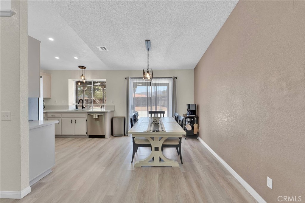 14769 Nanticoke Road Apple Valley, CA 92307 - Photo 7 of 30 a living room with furniture a dining table and chairs