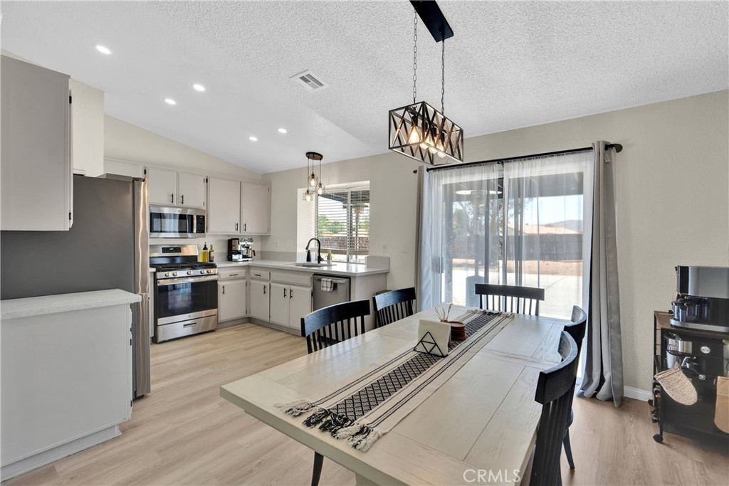 14769 Nanticoke Road Apple Valley, CA 92307 - Photo 9 of 30 a large kitchen with kitchen island a large counter space a sink appliances and a counter top space