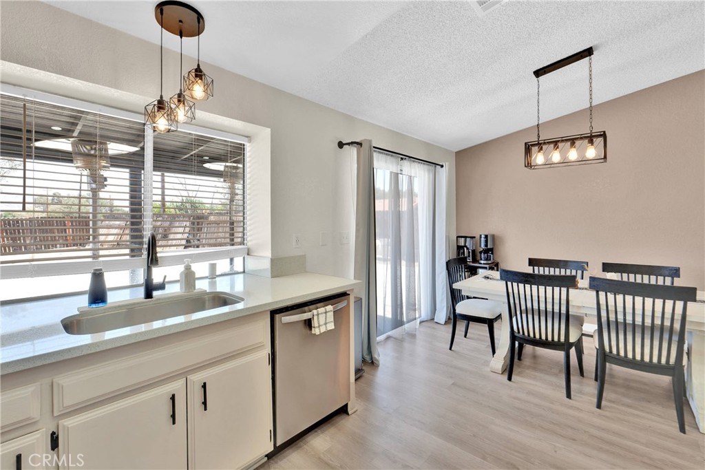 14769 Nanticoke Road Apple Valley, CA 92307 - Photo 10 of 30 a dining hall with granite countertop a sink a dining table and chairs