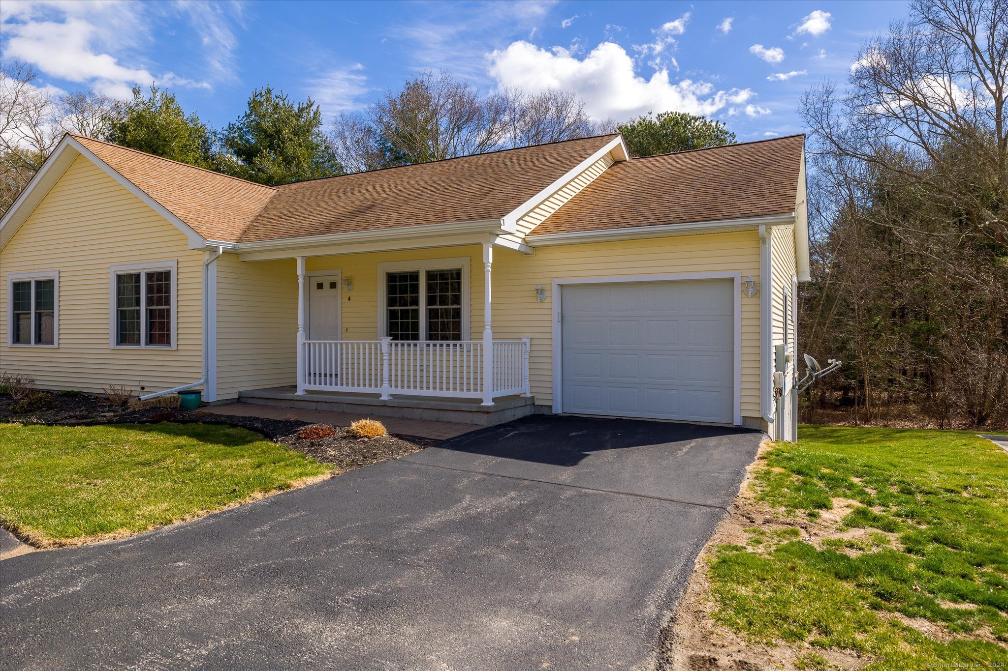 4 Bluebird Lane, Unit 4 Killingly, CT 06241 - Photo 1 of 1 a front view of house with yard and trees in the background