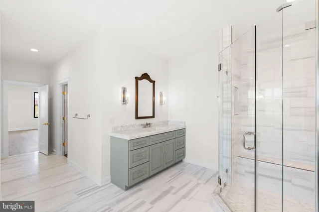 a bathroom with a shower sink and mirror