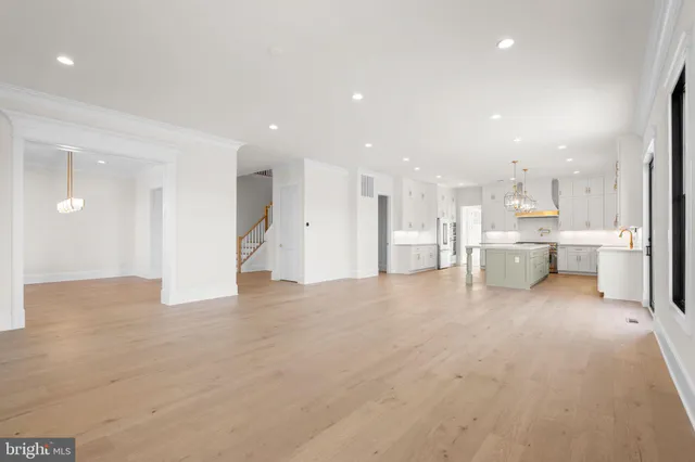 a view of a kitchen with kitchen island and stainless steel appliances