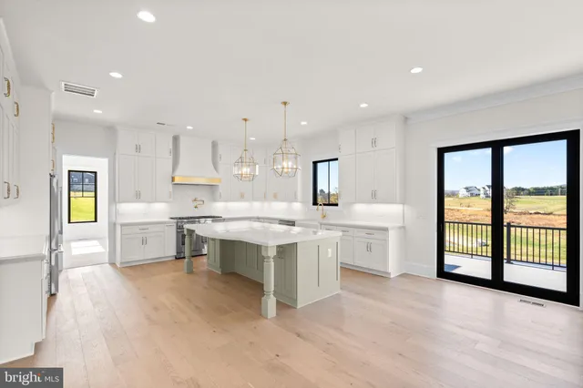 a large white kitchen with a large window