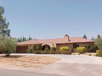 13806 Okesa Road Apple Valley, CA 92307 - Photo 1 of 1 a front view of a house with a yard