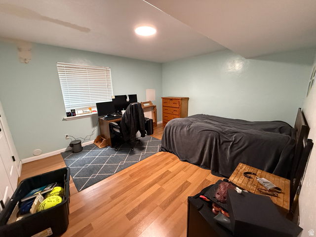 1353 360 West Payson, UT 84651 - Photo 11 of 16 Bedroom featuring light blue walls, wood-finish flooring, and a window with blinds