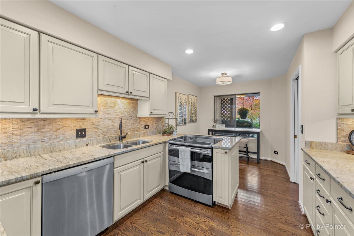 831 Shoreline Road Lake Barrington, IL 60010 - Photo 12 of 47 a kitchen with a sink stove and cabinets
