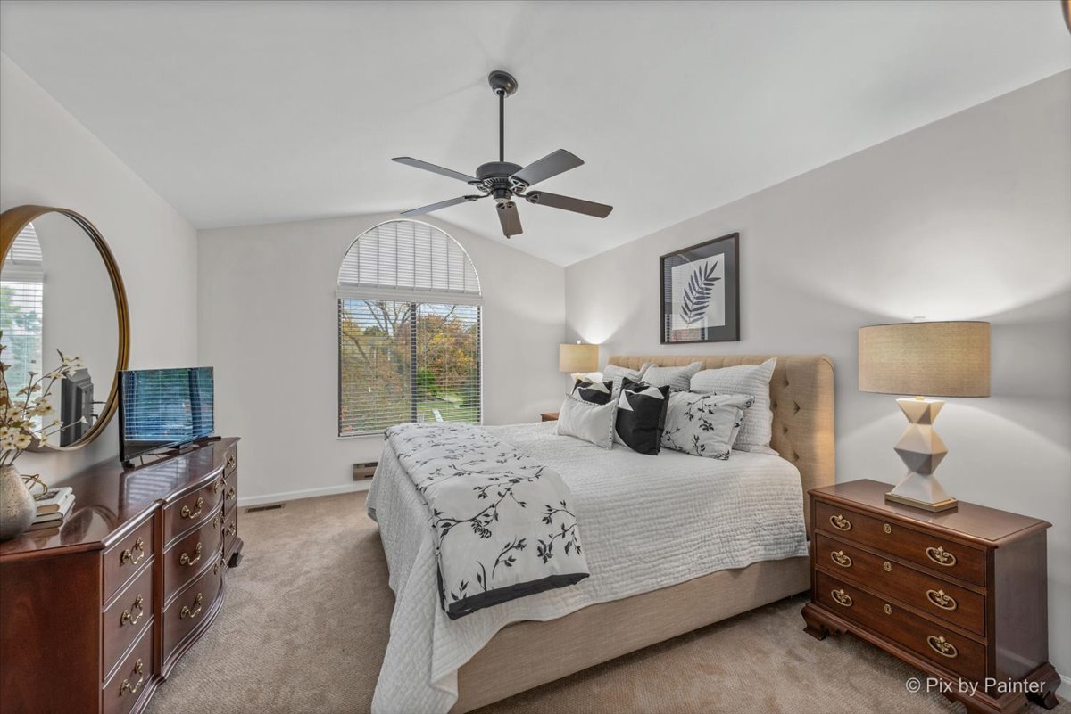 831 Shoreline Road Lake Barrington, IL 60010 - Photo 17 of 47 a bedroom with a bed a window and a flat screen television