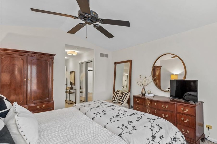 831 Shoreline Road Lake Barrington, IL 60010 - Photo 18 of 47 a bedroom with a bed and a flat screen tv on dresser