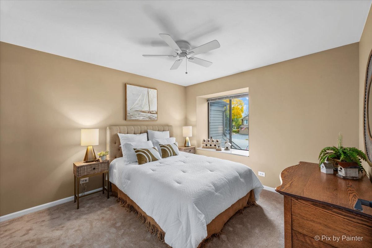 831 Shoreline Road Lake Barrington, IL 60010 - Photo 22 of 47 a bedroom with a bed and a table in it