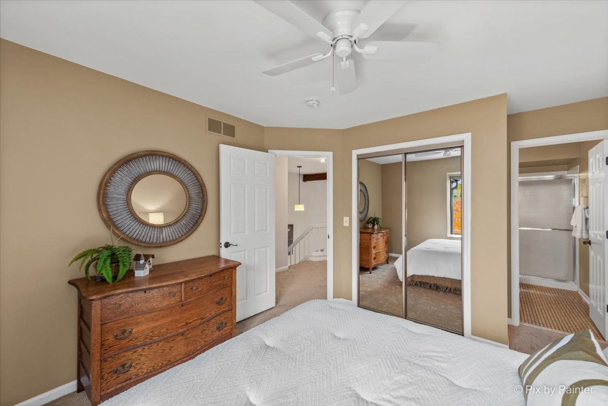831 Shoreline Road Lake Barrington, IL 60010 - Photo 23 of 47 a bedroom with a bed mirror and a desk