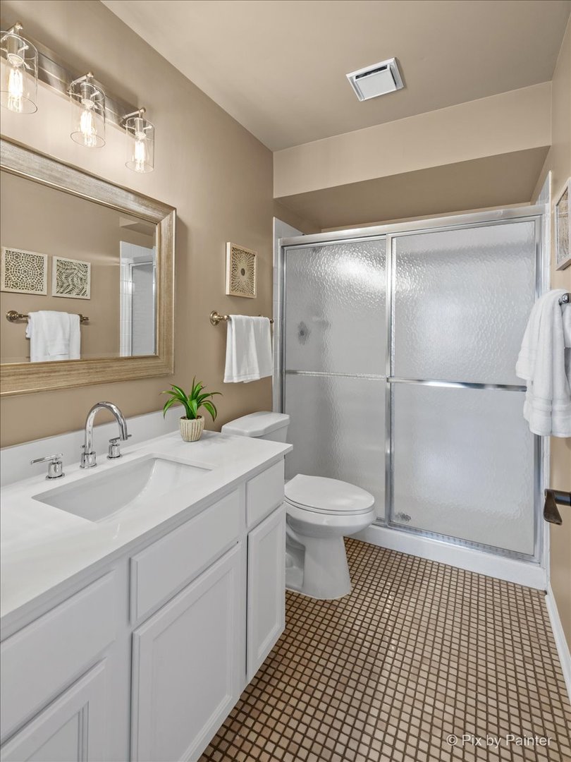 831 Shoreline Road Lake Barrington, IL 60010 - Photo 24 of 47 a bathroom with a sink a toilet and shower