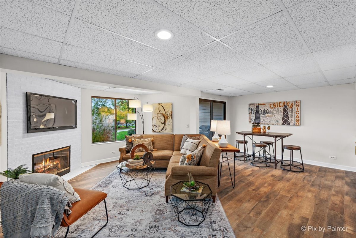831 Shoreline Road Lake Barrington, IL 60010 - Photo 26 of 47 a living room with furniture a fireplace a rug and a window