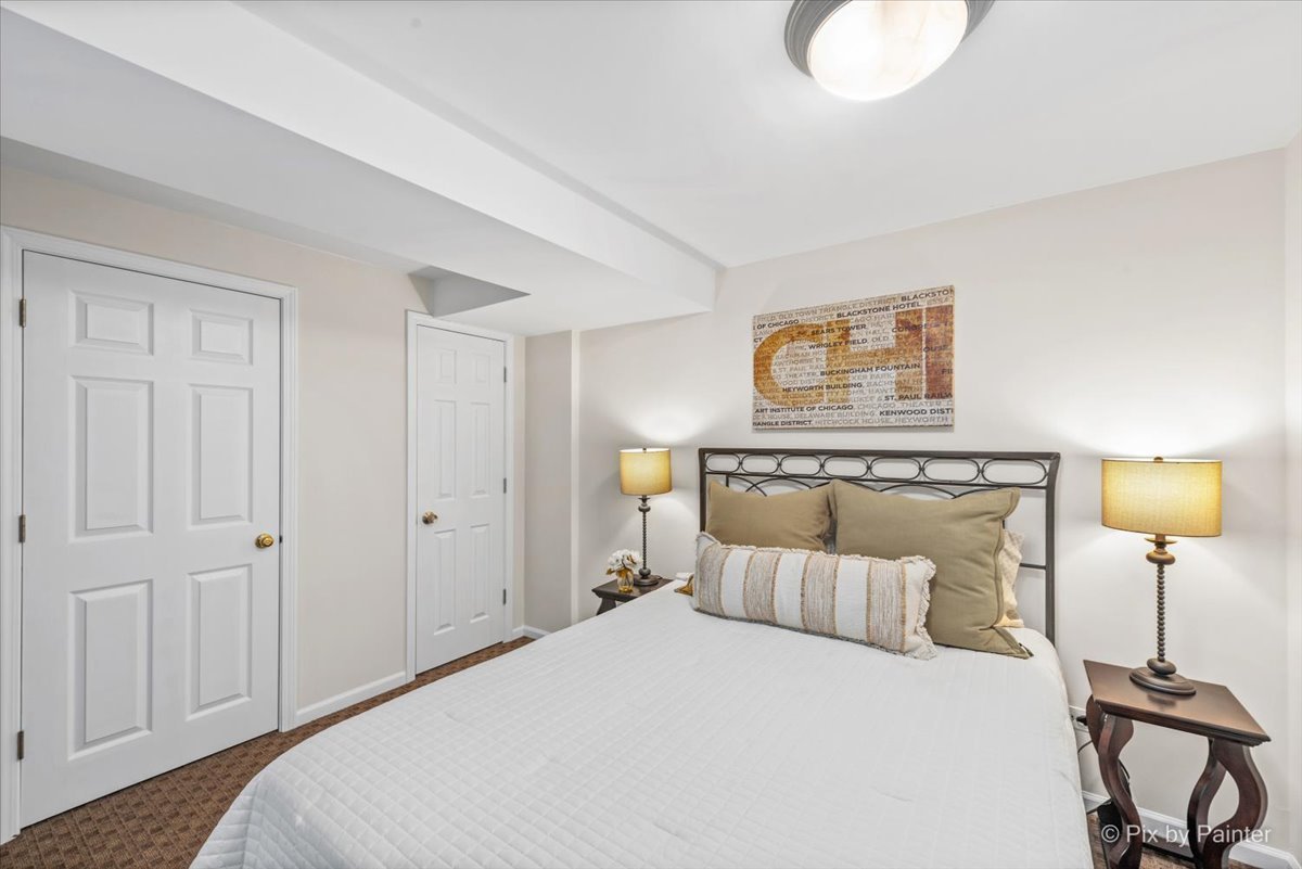 831 Shoreline Road Lake Barrington, IL 60010 - Photo 30 of 47 a bedroom with a bed and a lamp on table