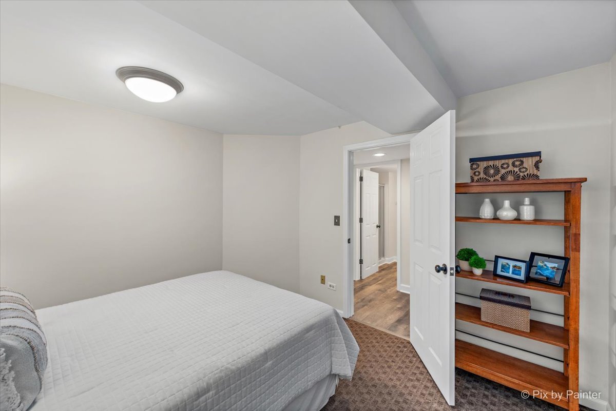 831 Shoreline Road Lake Barrington, IL 60010 - Photo 31 of 47 a bedroom with a bed and a book shelf