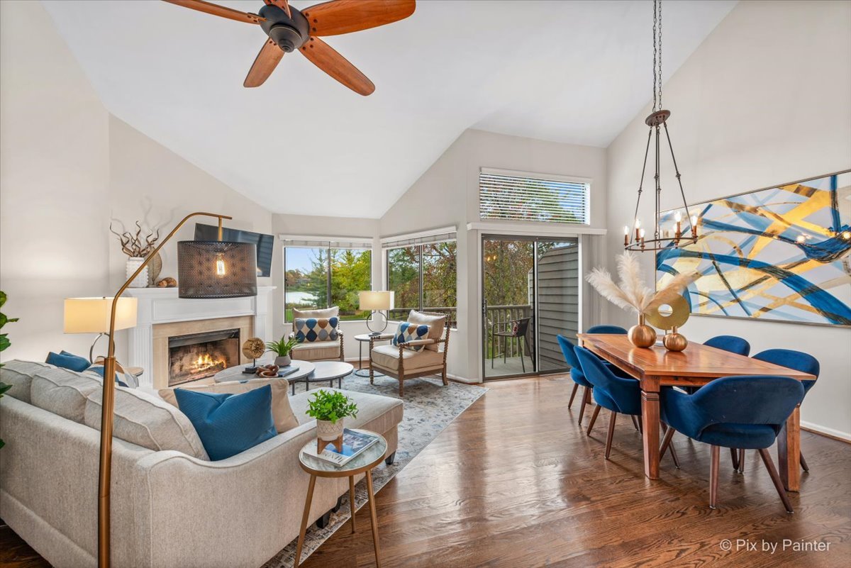 831 Shoreline Road Lake Barrington, IL 60010 - Photo 6 of 47 a living room with furniture a fireplace and a floor to ceiling window