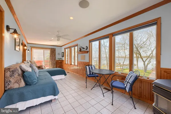 a living room with furniture and large windows