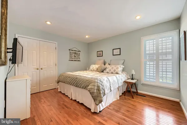 a spacious bedroom with a large bed and a tv