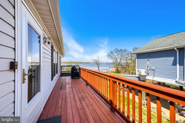 a view of balcony with wooden floor and fence