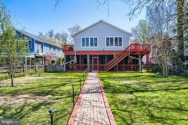 a front view of a house with a yard table and chairs