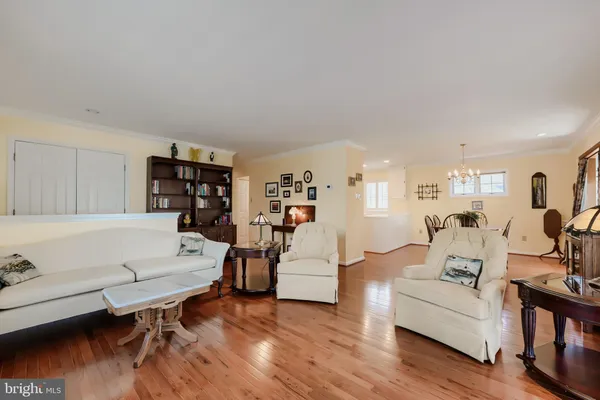 a living room with furniture wooden floor and a table