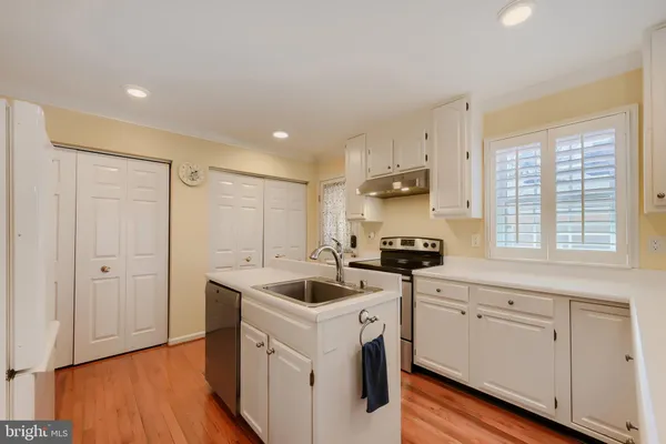 a kitchen that has a sink and a stove in it