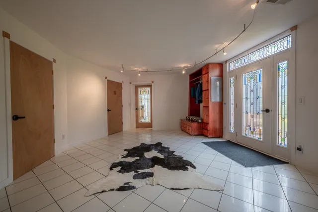a view of a livingroom with furniture and a hallway