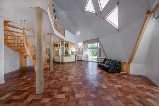 a walk in closet with wooden floor