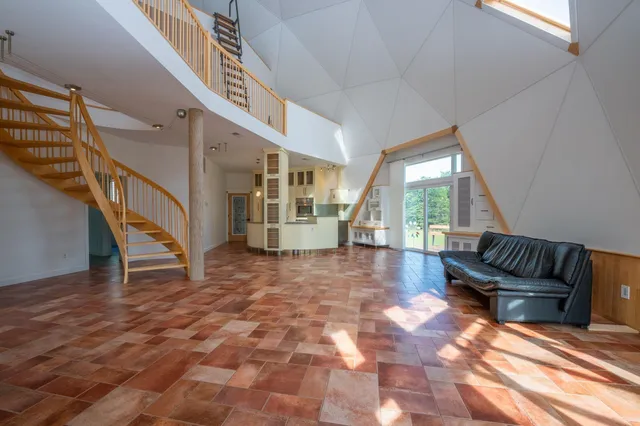 a kitchen with stainless steel appliances kitchen island granite countertop a refrigerator and a stove