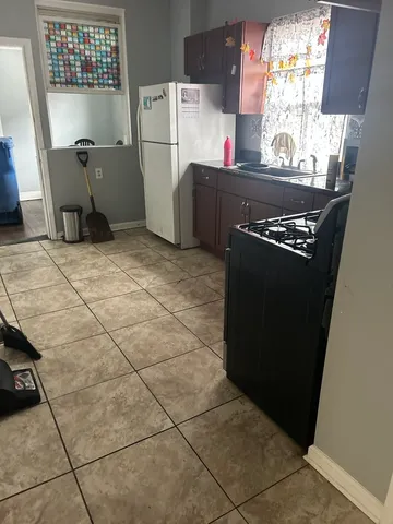 a kitchen with a refrigerator and a stove