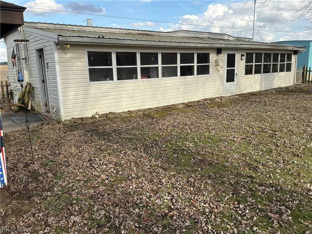 View of side of home featuring a metal roof