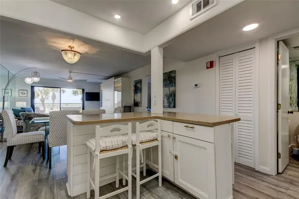 a open kitchen with a stove a sink and a refrigerator