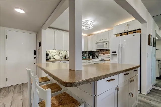 a kitchen with stainless steel appliances granite countertop a sink a stove and a refrigerator