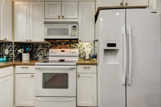 a kitchen with appliances cabinets and a counter top space