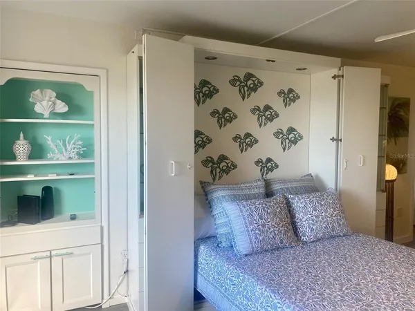 a large bedroom with a bed and a window