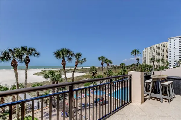 a view of a balcony with potted plants