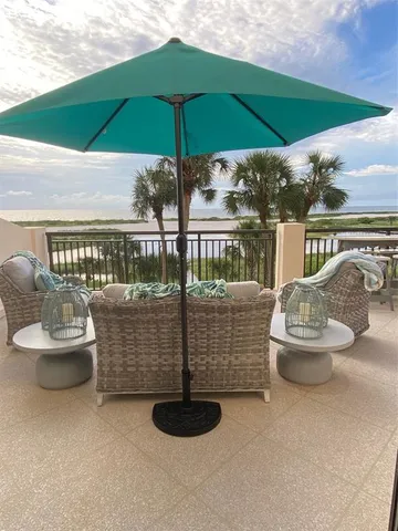 a view of a swimming pool with a table and chairs