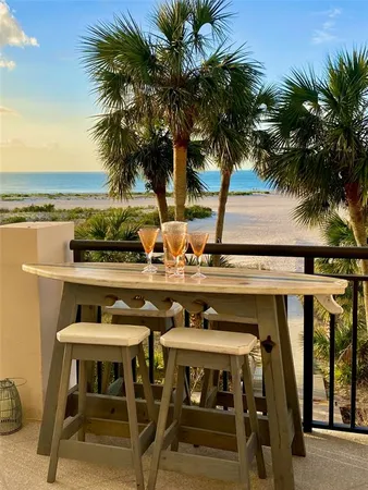 a view of a patio with table and chairs and potted plants with sky view