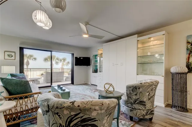 a living room with furniture a flat screen tv and a window