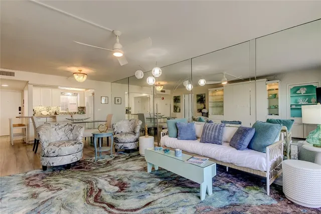 a living room with lots of furniture and view of kitchen