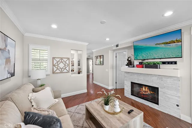 a living room with furniture fireplace and flat screen tv