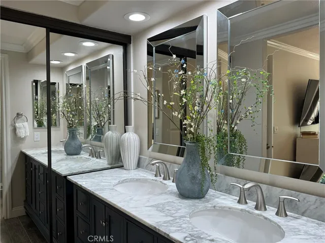 a bathroom with a granite countertop sink a mirror and shower