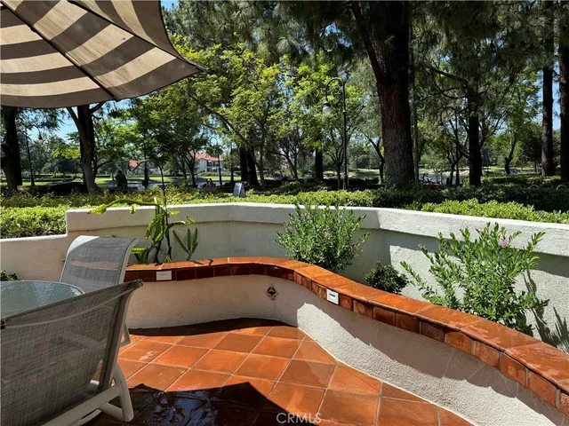 a view of a swimming pool with a patio and a yard