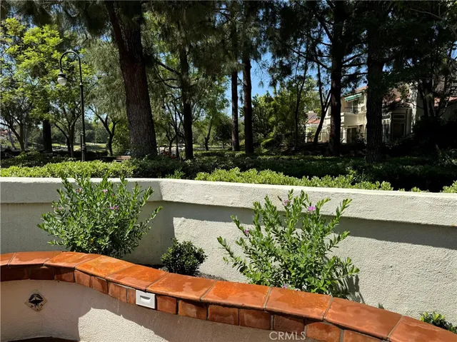a view of a yard with wooden fence