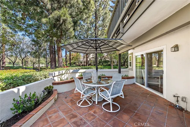 a view of a patio with a table chairs and backyard