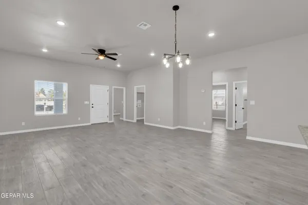 a bathroom with a granite countertop toilet sink and mirror