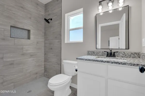 a bathroom with sinks a vanity and a large mirror