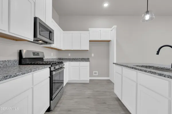a kitchen with sink and cabinets